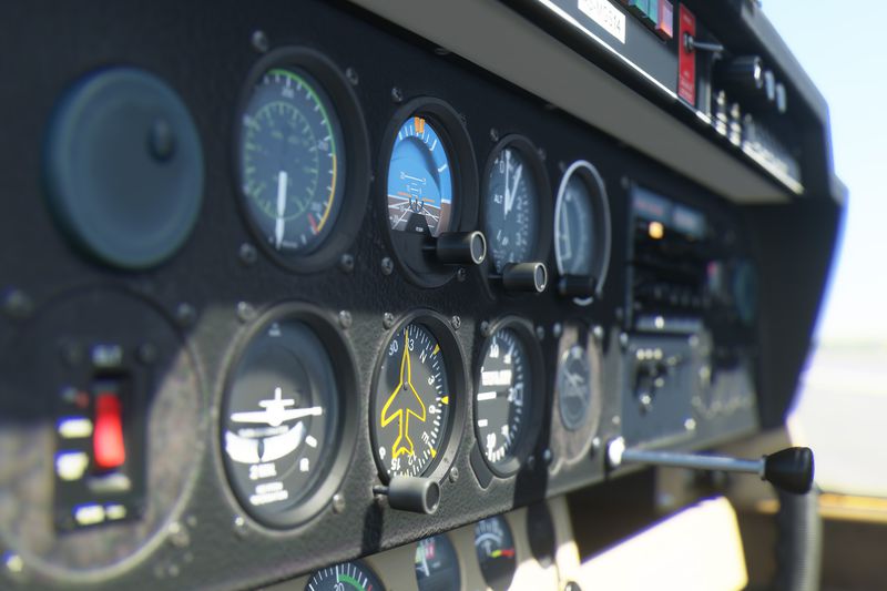 A close up of the instrumentation panel in a simulated aircraft. From an early sample of Microsoft Flight Simulator. The image shows extreme depth of field effects and high-resolution textures.