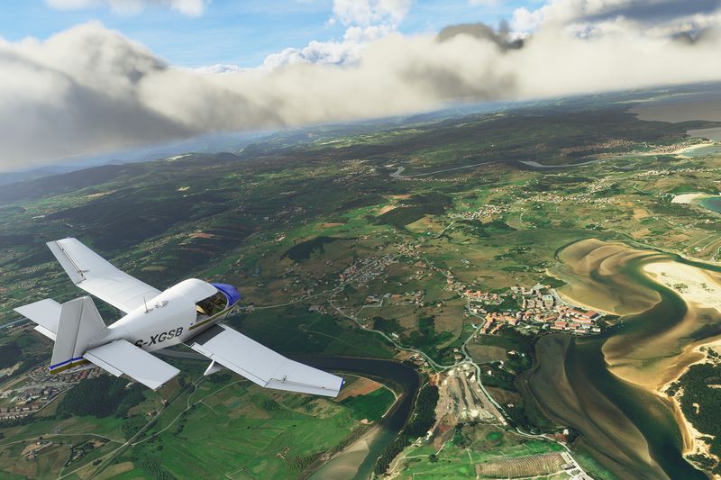 A French-made DR400 over a winding river, its wandering path clearly visible from several thousand feet in the air. The sky is blue with few clouds. From an early pre-alpha of Microsoft Flight Simulator
