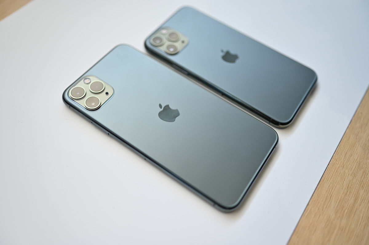 The backside of an iPhone 11 Pro Max and Pro, set on a table.