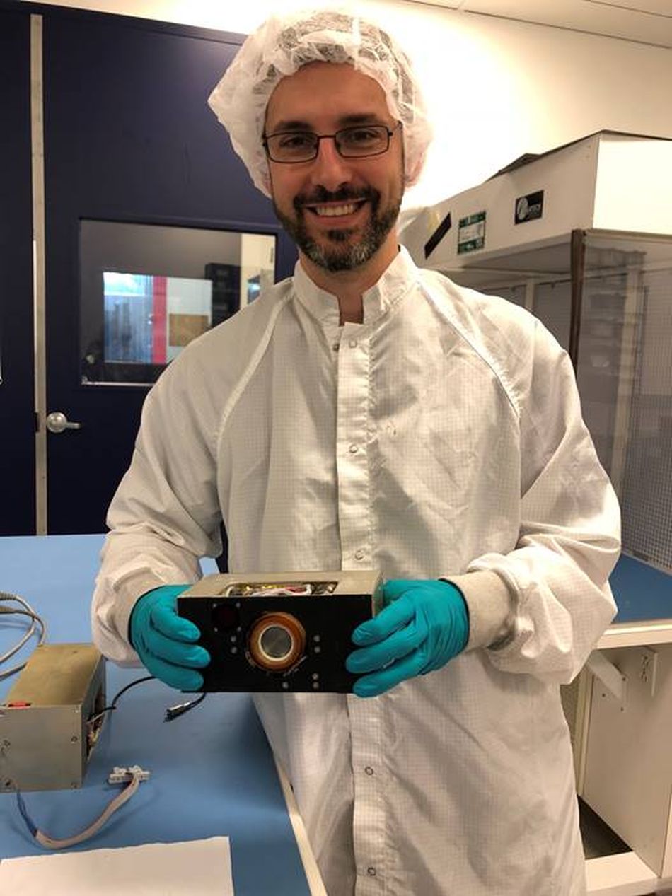 Dr. Hardgrove holding the flight LunaH-Map propulsion system. The propulsion system is very low thrust but is incredibly efficient. Over time, the low thrust is enough to allow the LunaH-Map spacecraft to enter lunar orbit and map south pole ice deposits.