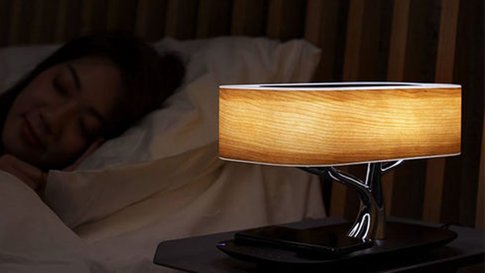 This cozy bedside lamp is actually a high-tech charger and speaker system